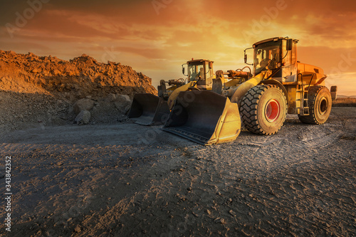 Fotografía Two excavators moving stone and rock in a quarry