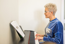 Stylish Adult Woman Playing Synthesizer