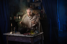 Elderly Alchemist Monk Brews  Magic Potion