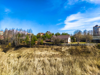 Wall Mural - image of country houses against the background of a spring landscape