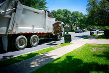 Municipal Services. Beautiful Quiet Green Neighborhood. Automated Modern Garbage Collector Truck Loading  Waste. 
