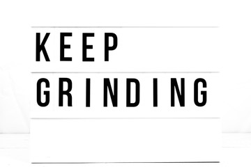 Wall Mural - Inspirational Keep Grinding quote on vintage retro board. Concept. flat lay