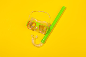 Wall Mural - Diving mask on yellow background. Concept of beach holiday, sea tour, warm sunny summer. Advertising space