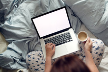 Woman girl in pajamas with laptop on bed, mockup