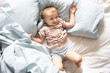 Caucasian baby in pajamas on the bed