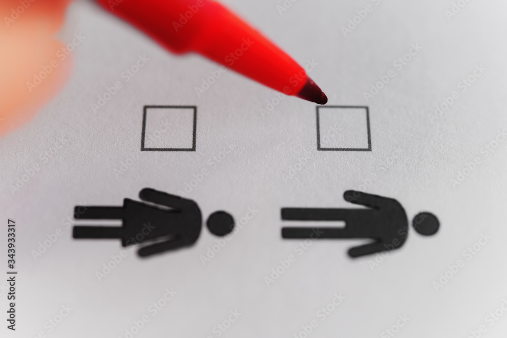 Person marking with pen on male and female gender checklist Stock Photo ...