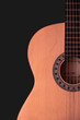 © ramoshots - Acoustic guitar on a black background for playing music.