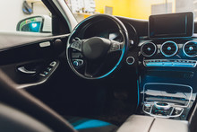 Dark Luxury Car Interior - Steering Wheel, Shift Lever And Dashboard. Car Interior Luxury. Beige Comfortable Seats, Steering Wheel, Dashboard, Climate Control, Speedometer, Display.