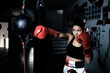 © Cavan Images - Young woman practicing boxing at gym