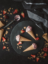 Top View Of Strawberry Ice Cream Cones On A Black Background.