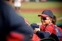 Boy Wearing Sunglasses And Smirking In Baseball Uniform