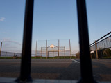 Fototapeta Sport - basketball court in the background of the setting sun, top view, free space for inscriptions, sad view of empty basketball courts