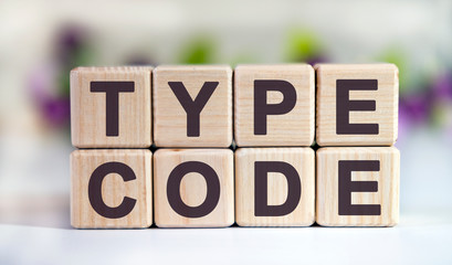 Poster - TYPE CODE - text on wooden cubes on a floral background with tulip buds