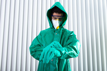 Wall Mural - Man wearing impermeable whole-body garment before starting his work