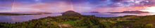 Aerial View Of A Beautiful Island Sunset With A Gorgeous Rainbow. Springtime Brings Dramatic Sunsets And Colorful Rainbows But Hardly Ever Both. This Is Lummi Island, Washington In The Salish Sea.