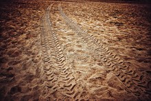 High Angle View Of Tire Tracks On Sand