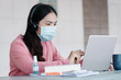 © EduLife Photos - Portrait of a young Asian female adult learner studying online at home during Coronavirus or COVID-19  pandemic. Businesswoman wear mask works with laptop at home in house corridor and garden.