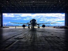 Airplane On Airport Hanger Against Sky