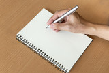 Fototapeta Konie - man hand with pen prepare to writing on notebook