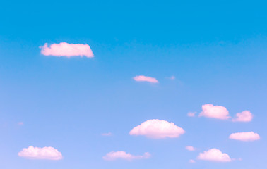 small pink clouds floating on blue sky with day light