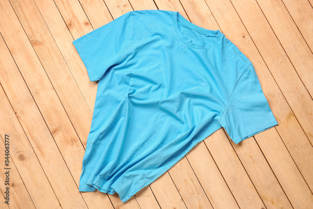 Stylish t-shirt on wooden background