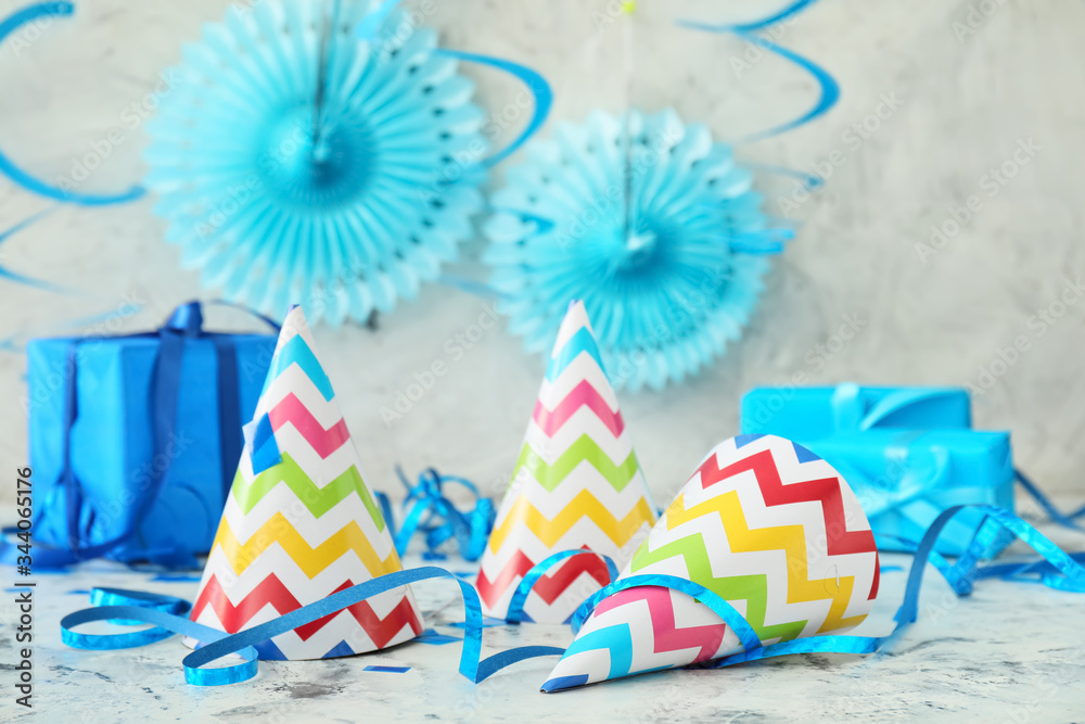 Party hats and decor on light background
