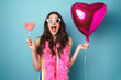 © Drobot Dean - Photo of delighted young woman posing with balloon and lollipop