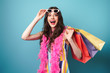 © Drobot Dean - Photo of surprised young woman holding shopping bag and sunglasses
