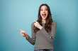 © Drobot Dean - Photo of excited nice woman in striped sweater pointing fingers aside