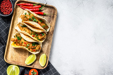 Traditional Mexican tacos with parsley, cheese and chili peppers. White background. Top view. Copy space