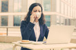 © Mangostar - Businesswoman drinking coffee and using laptop. Serious middle aged businesswoman working with laptop computer while sitting at table in outdoor cafe. Technology concept