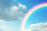 Fototapeta Tęcza - Picturesque view of beautiful rainbow and blue sky on sunny day