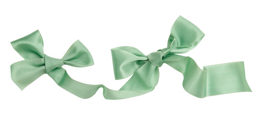 Wall Mural - Green ribbon curl isolated on white background. Bright green ribbon bow and curl isolated on white background. Textile accessories for sewing and gift scrapbooking decorations. Atlas or silk ribbon