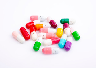 Different color pills on white background