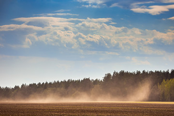 dust storm in dry fields, dry weather infuenced by climate change