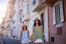 Mother and her daughter walking at the streets of Monte Carlo