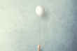 Leinwandbild Motiv hand lets white balloon fly free