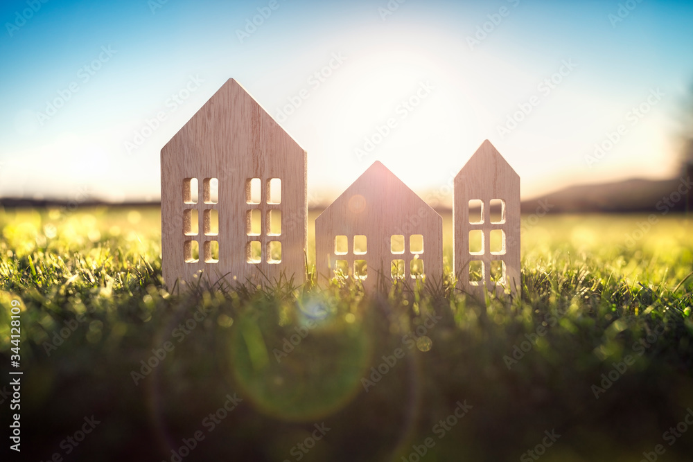 Ecological wood  model house in empty field at sunset - obrazy, fototapety, plakaty 
