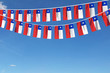 Chile flag festive bunting hanging against a blue sky. 3D Render