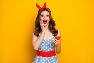 Canvas Print - Surprised excited energetic girl use cell phone get new followers subscribers blogging social media post scream wow omg touch hands face wear red headband isolated bright shine color background