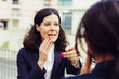 © Mangostar - Emotional businesswoman talking with colleague. Excited middle aged businesswoman pointing with finger and talking with young colleague on street, selective focus. Cooperation concept