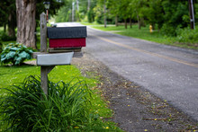 A Traditional American Mailbox On The Side Of A Village Road