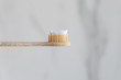 Toothbrush made of eco-friendly material: bamboo and wood. A major bristle plan with paste on a white background.