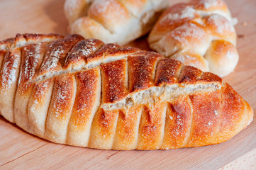 Freshly baked loaf of bread, buns, closeup.