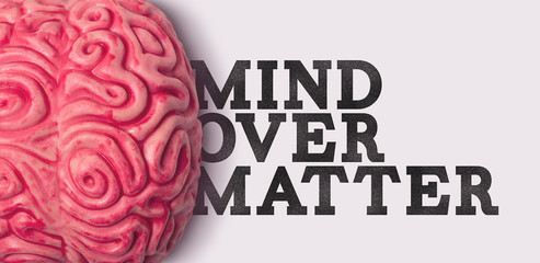 Wall Mural - Mind Over matter word next to a human brain model