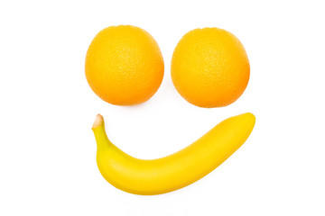 Wall Mural - Smiling face banana and oranges on a white background