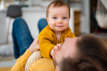 Loving father and his little daughter playing and bonding at home