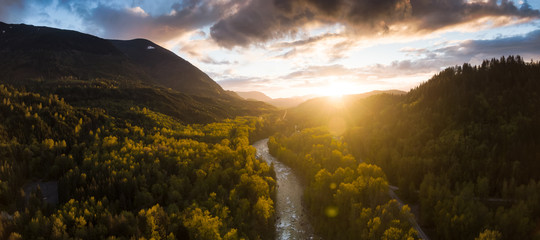 Wall Mural - Aerial Panoramic View of the Beautiful Valley with Canadian Mountain Landscape during Colorful Sunset. Taken near Chilliwack, East of Vancouver, British Columbia, Canada.