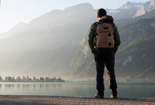 Man Standing At The Edge Of The Beautiful Lake Brienz On A Fall Morning In Switzerland