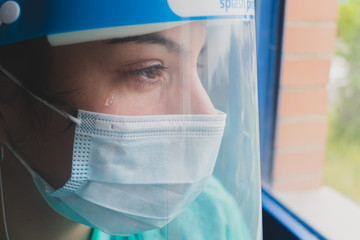 Doctor in PPE suit has stress in Coronavirus outbreak or Covid-19, Covid-19 Quarantine Concept. Emotional stress of doctor and health care team with overwork during Covid-19 period.